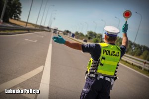 Policjant zatrzymuje pojazd do kontroli drogowej.