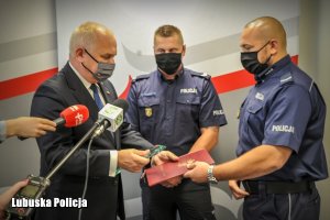 Wojewoda dziękuje policjantowi. Uściska dłoni