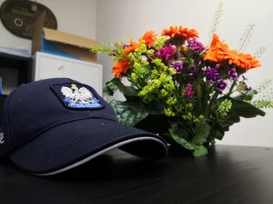 Policyjna czapka przy wiązance kwiatów