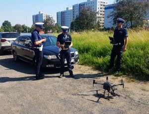 Policjanci ruchu drogowego przygotowują się do startu drona