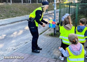 Policjantka odbiera laurkę od dzieci.
