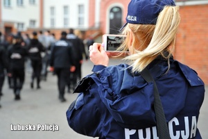 Policjantka robiąca zdjęcie uczniom klasy policyjnej