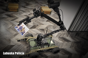 Robot pirotechniczny trzymający ulotkę promocyjną Lubuskiej Policji.