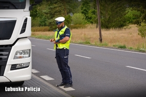 Policjant podczas kontroli pojazdu ciężarowego