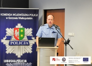 Policjant z Niemiec przemawiający z mównicy.