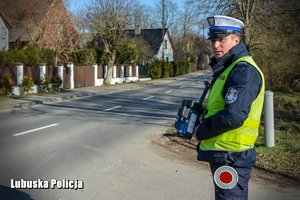 policjant stoi przy drodze