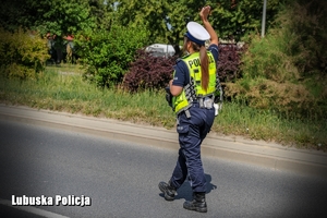 Policjantka daje kierowcy znak do zatrzymania