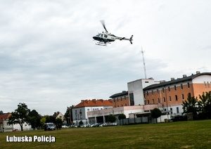 Helikopter na tle komendy Policji.