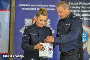 policjant wrzuca datki do puszki