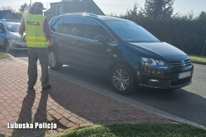 Policjant, w tle widoczny pojazd