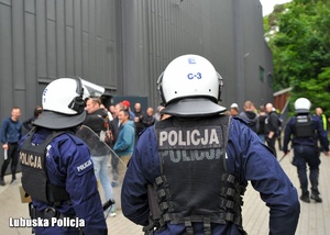Policjanci podczas ćwiczeń, w tle kibice.