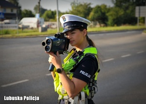 Policjantka podczas kontroli prędkości jadących pojazdów.