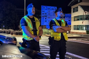 Policjanci stoją w obrębie przejścia granicznego.