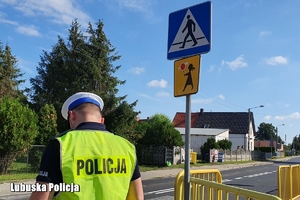 policjant sprawdza oznakowanie na drodze