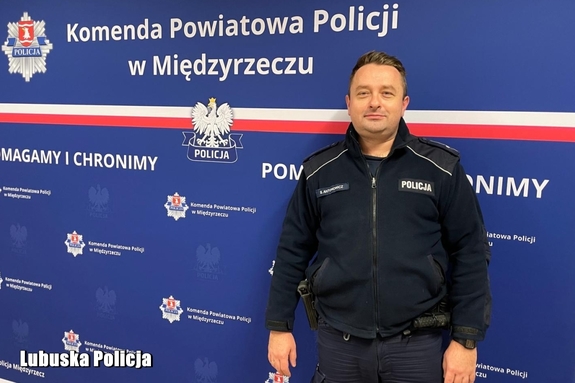 policjant stoi przy ściance