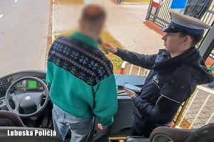 policjant kontroluje stan trzeźwości kierowcy autokaru