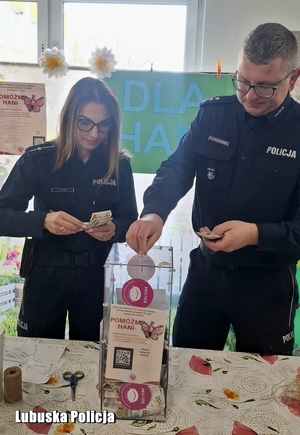 policjanci wrzucają pieniądze do urny