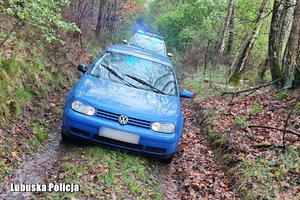 radiowóz stoi za osobowym Volkswagenem