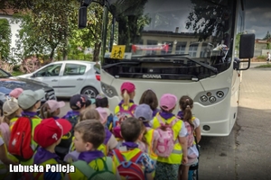 dzieci stoją przed autobusem