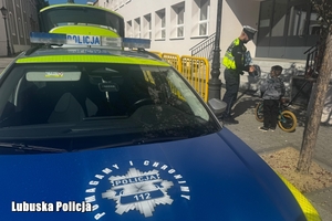 policjant wręcza kask osobie